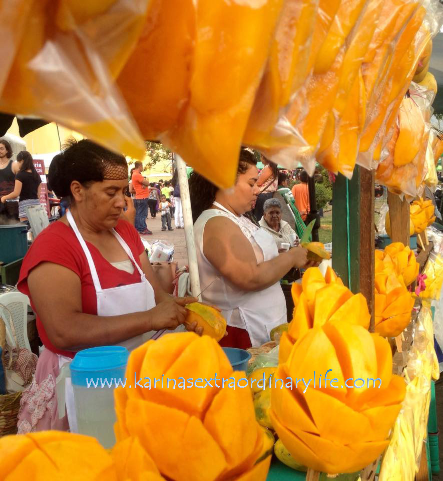 Mujeres preparing mangoes in a stand they set up in the street. Antigua, Guatemala -- April Beresford