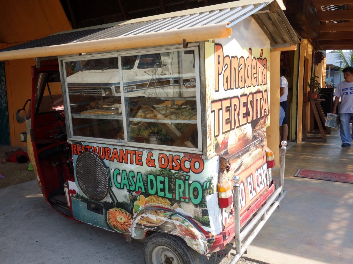 A 3-wheeled motorbike (tuktuk) converted into a mobile bakery. Rio Dulce, Guatemala -- Karina Noriega