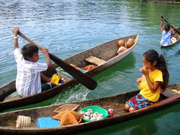 Children selling sea goodies in typical cayucos, Rio Dulce, Guatemala -- Karina Noriega