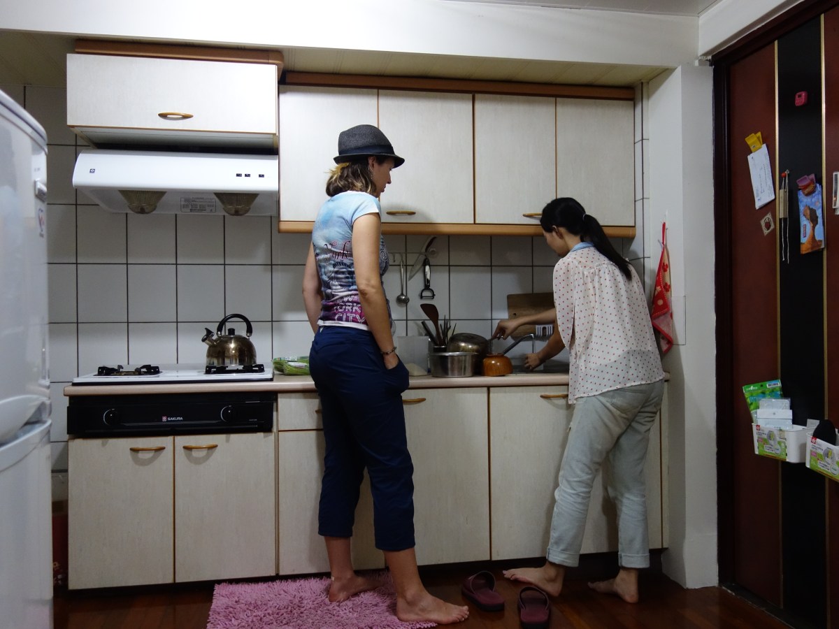 April (the apprentice), observing Chef Sharon as she strains random green veggy with no English name. The meal also consisted of duck blood rice, ground pork with onion and steamed rice. Taipei, Taiwan - Karina Noriega